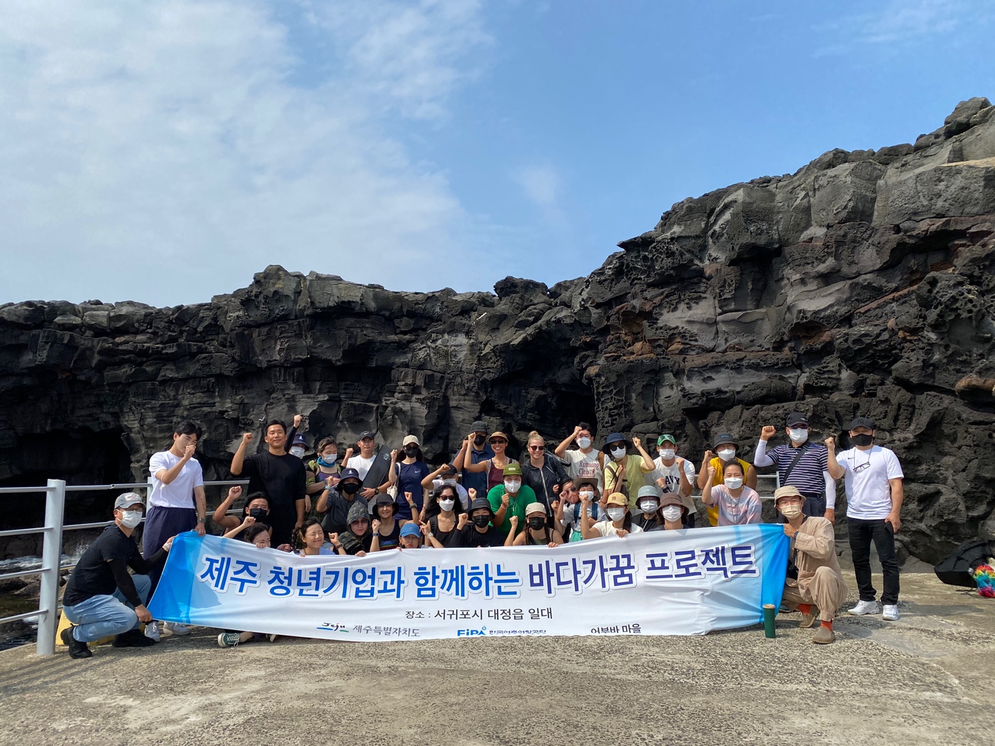 제5회 바다가꿈 프로젝트 (제주 청년기업과 함께하는 바다가꿈 프로젝트 장소 : 서귀포시 대정입 일다, Jeju 제주특별자치도, FiPA , 어부바마을)이 적혀있는 현수막을 들고 찍은 단체사진1
